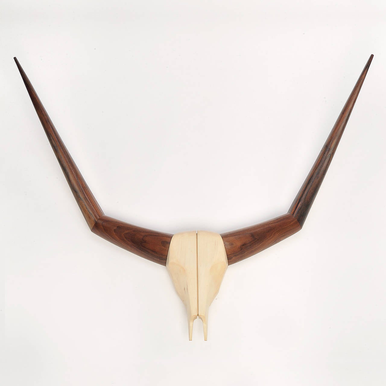 American deep walnut juxtaposes the beauty of blond sycamore to create a visually arresting likeness of cow horns.

We specialize in custom commissions.
Custom materials, finishes and dimensions available.