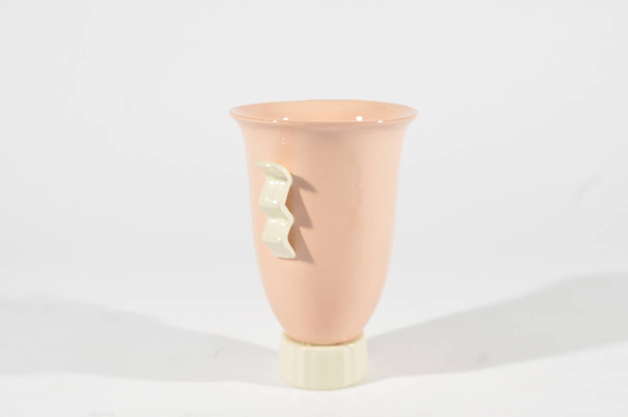 A great pastel pink and yellow accented vase with ribbed base and electric handles. Marked made in Belgium to bottom. 

Dimensions: H 9.5