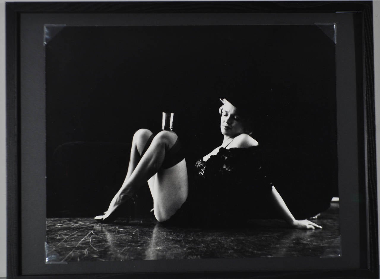 Untitled (Marilyn Monroe with a glass on her knee), silver gelatin print, dated 4-20-78 and signed to the back.

Dimensions: H 19