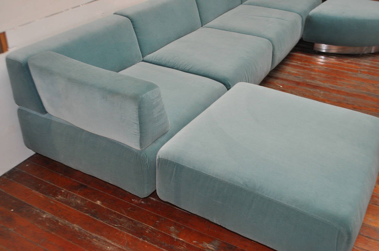 A stunning four-seat sofa by Harvey Probber with two carved ottomans upholstered in an original ice blue crushed velvet. The seats sit on a chrome clad plinth. All seats can come off the base and be placed around individually.

Dimensions:
