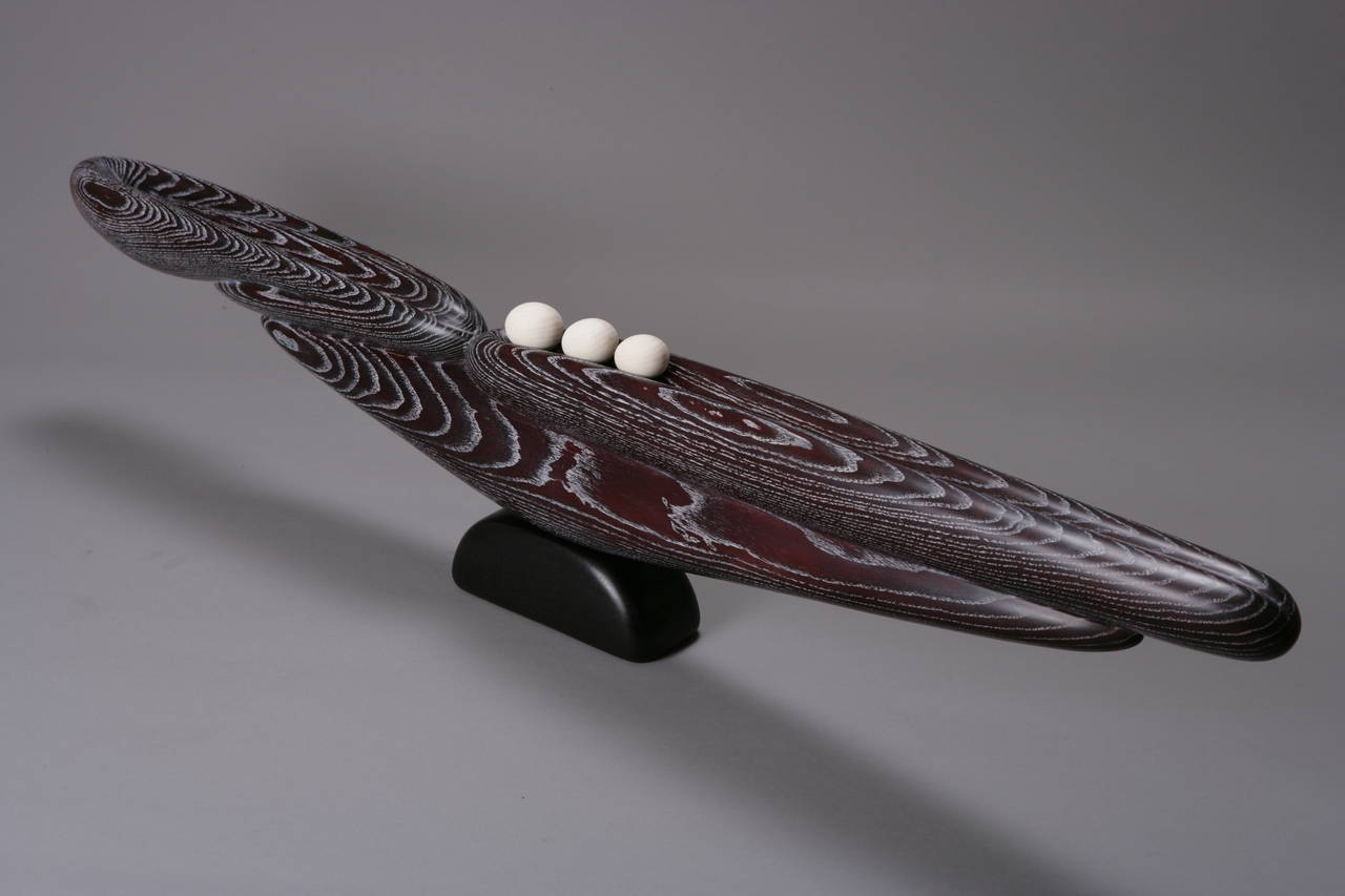 A beautiful studio sculpture by Betty Scarpino, renowned woodworker from Indianapolis, IN. This piece was executed in 2014 and consists of Ash, both bleached and limed. An elongated form harbors three spheres to one side, while resting on a base. 