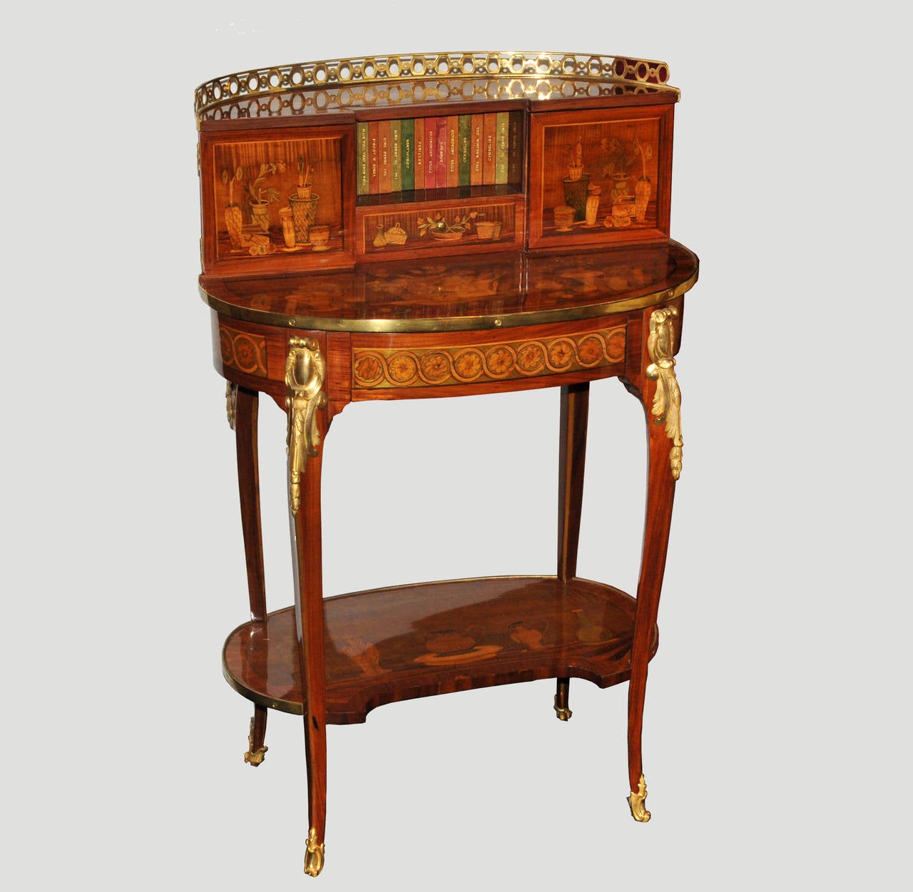 Bonheur-du-jour (women writing desk) inlaid with tulipwood, sycamore and purpleheart.

This exceptional escritoire inlaid with familiar objects opens with one main drawer discovering a writing case and two side drawers on the upper section. 
The