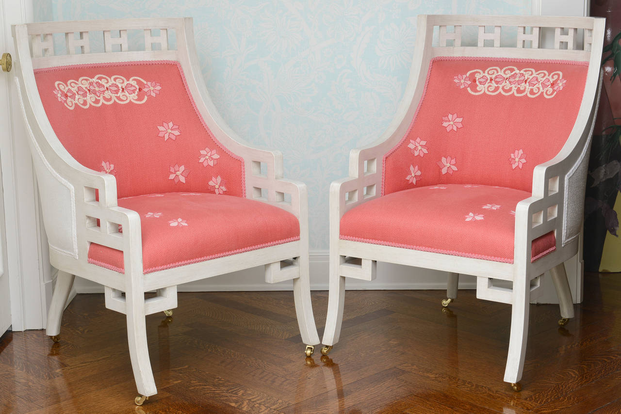 White painted framed with pierced fretwork ornament and finely embroidered coral linen upholstery. Beautifully made and very high quality pieces.