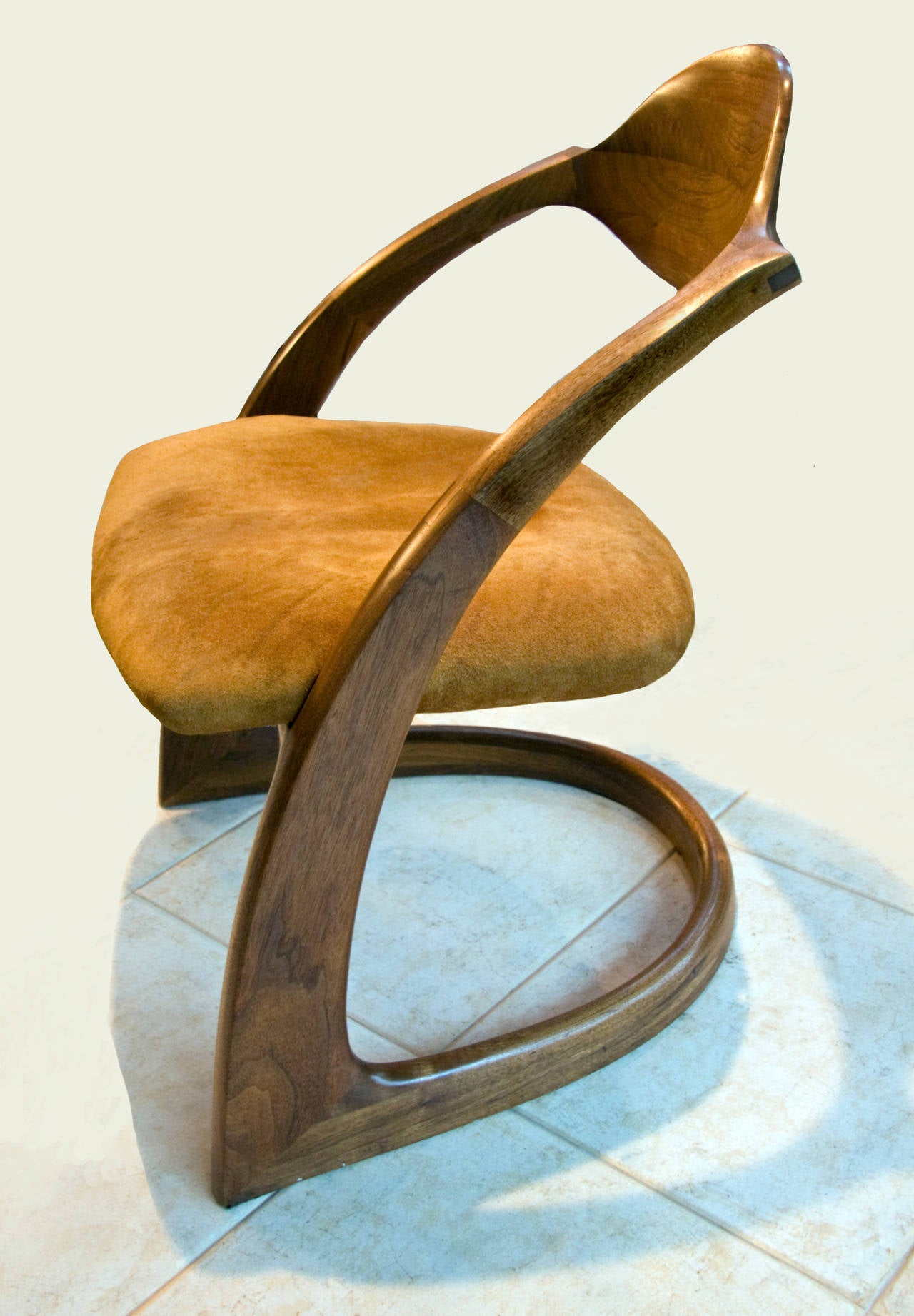 In walnut with original suede upholstered seats. One with repair to underside of stretcher performed by the Wendell Castle studio in the 1980s. Both signed and dated by the artist. These chairs are included in the forthcoming Wendell Castle