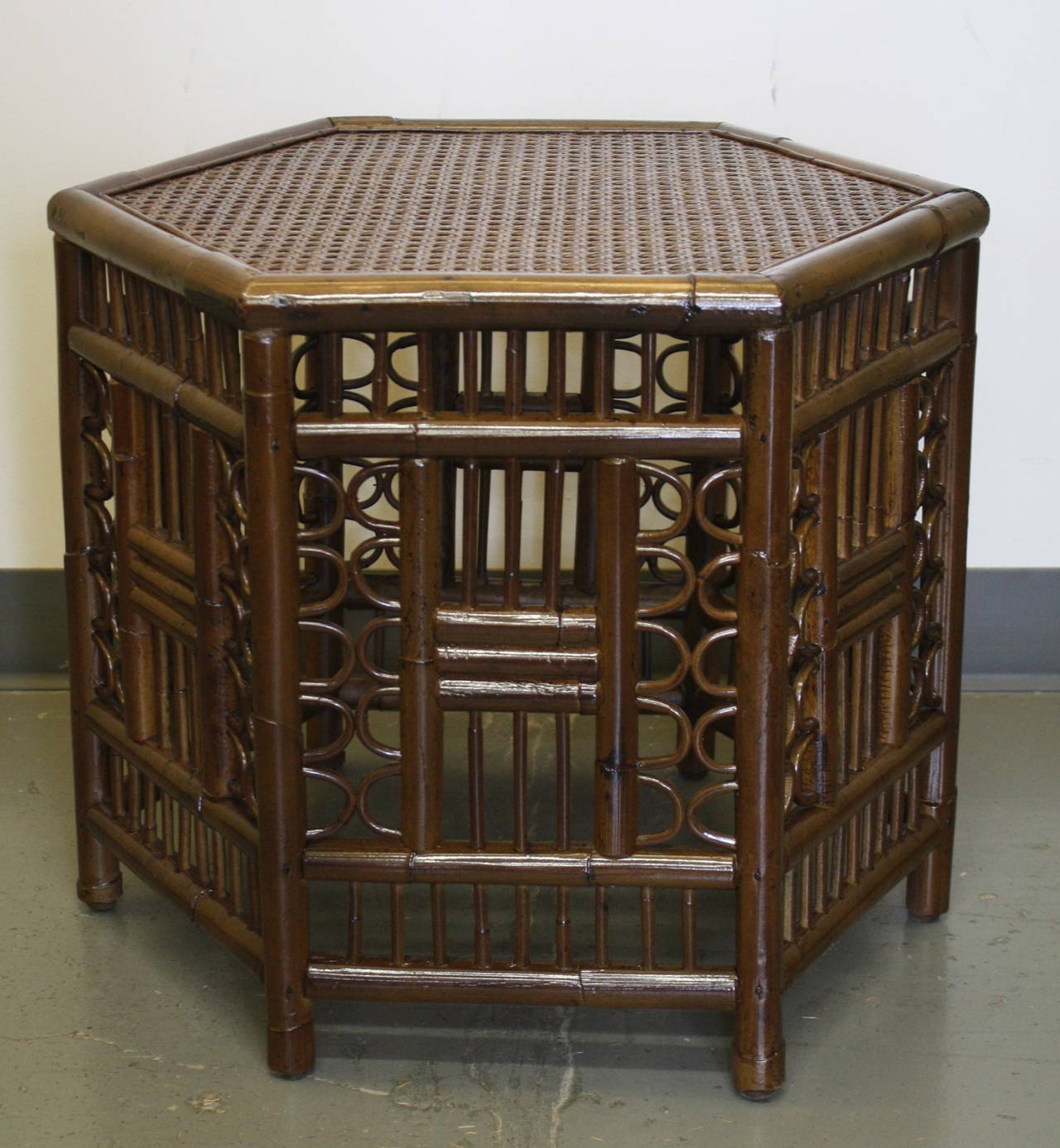 Each with hexagonal top inset with caning; raised on open fretwork supports. Recently restored to a glossy finish.