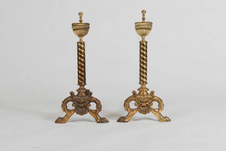 Each with spiral twist column surmounted by an urn and supported on paw feet.