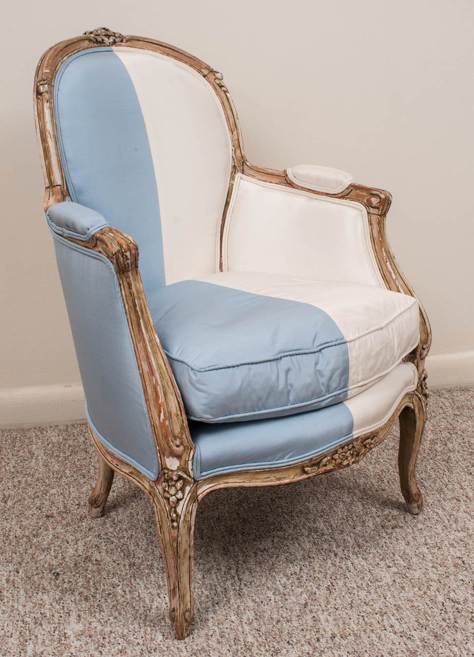 The pinewood stripped for a rustic look. Custom upholstered in ice blue and eggshell taffeta 