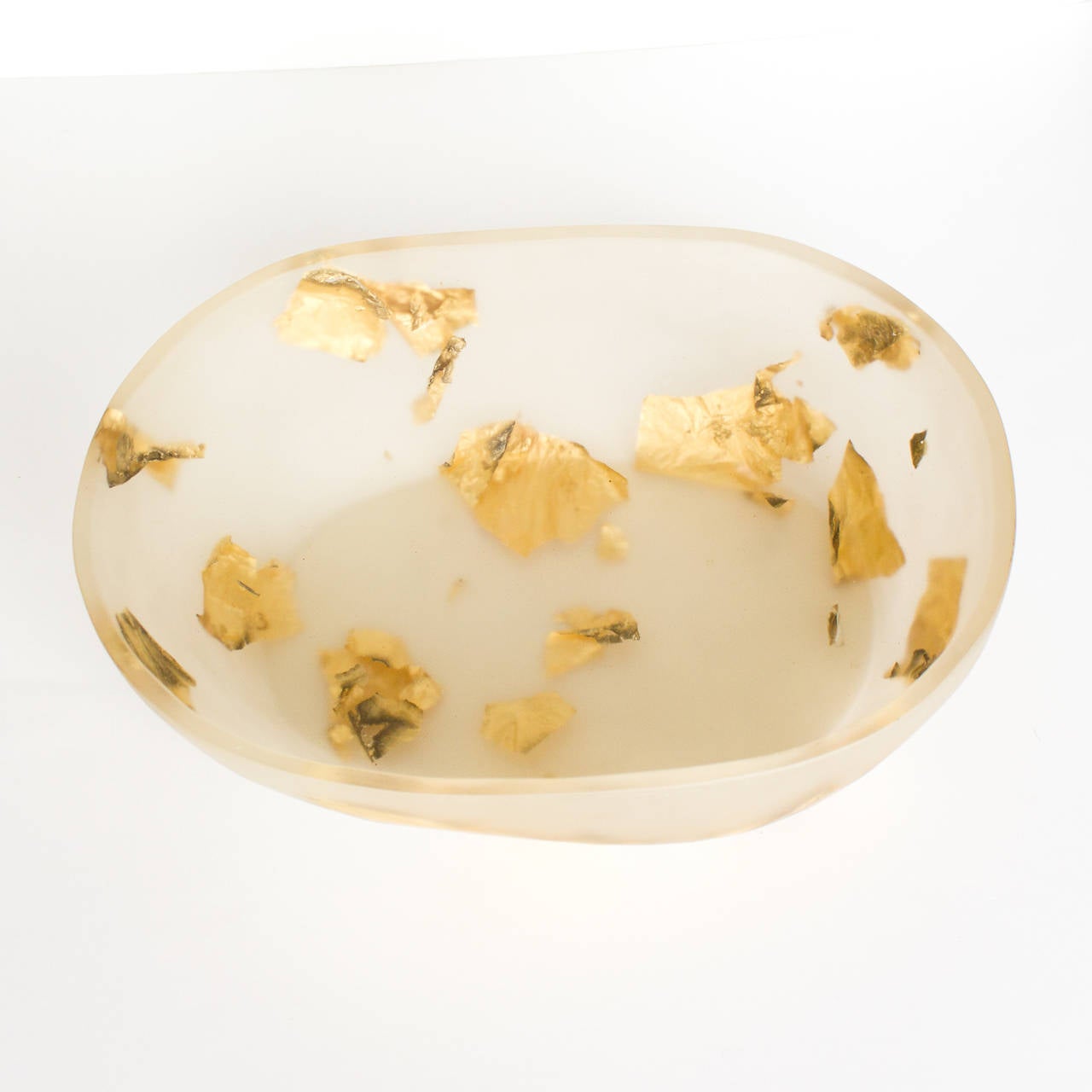 Bowl made from translucent resin with suspended sheets of gold leaf.