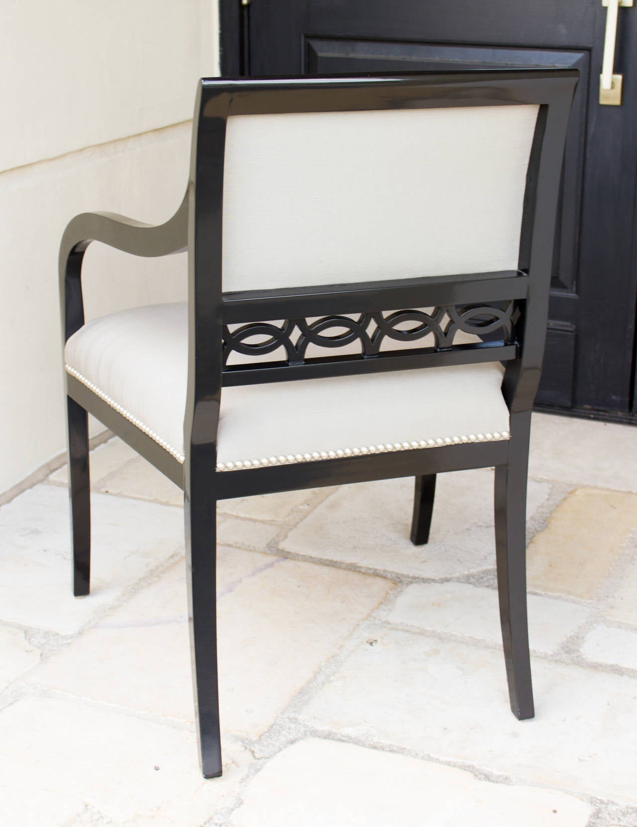 Black lacquer studded.
A pair of studded Chandler armchairs from the Robert Brown Collection. The chair's frame is finished in black lacquer. Designed by Robert Brown in Atlanta, handcrafted in England.