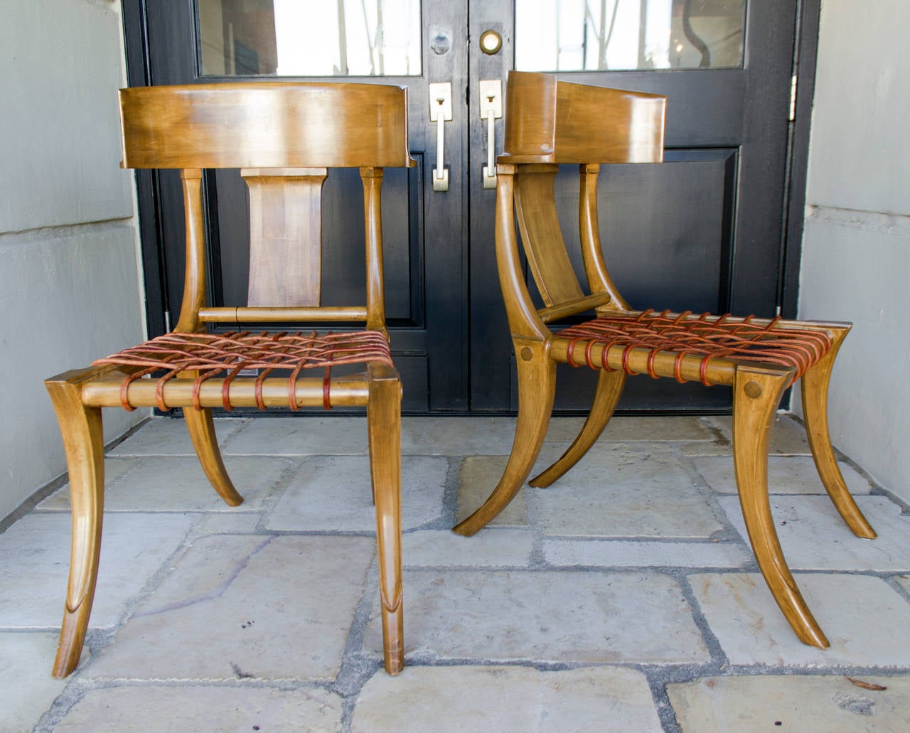 Rare vintage Klismos chairs with barrel backs and leather strap seats.