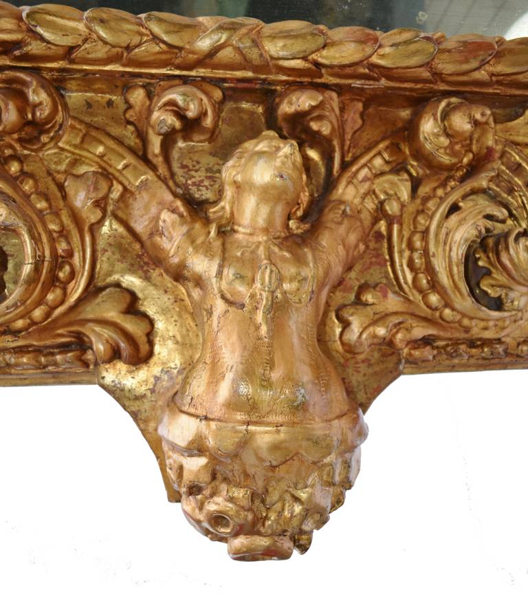 18th century Italian Baroque mirror with deeply carved acanthus leaves and a female figure at the base.
