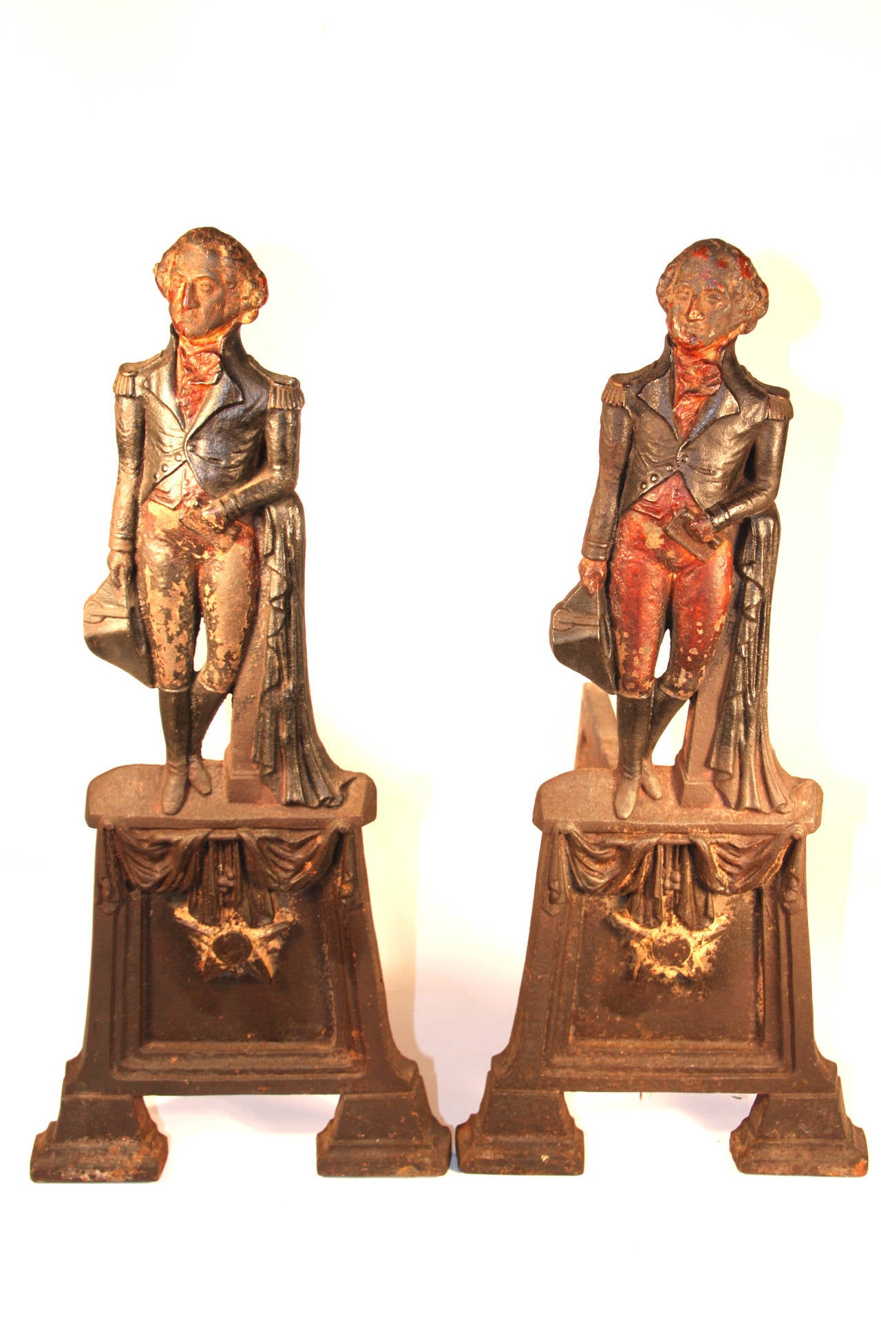 Pair of cast iron andirons in the form of George Washington on a draped plinth retaining an old polychrome decorated surface.  Late 19th century.  21