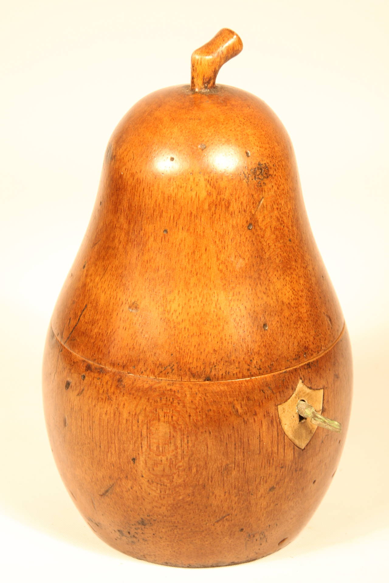 Fruitwood carved pear tea caddy.  19th century, carved with stem, having original locking mechanism and key. Lined with tinned paper.