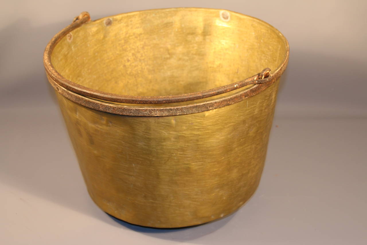 Circa 1840 Pennsylvania brass apple butter cauldron with hand forged iron handle.  All original with scratches and dents consistent with age and use.

Great architectural element for indoor or outdoor use.

12.25