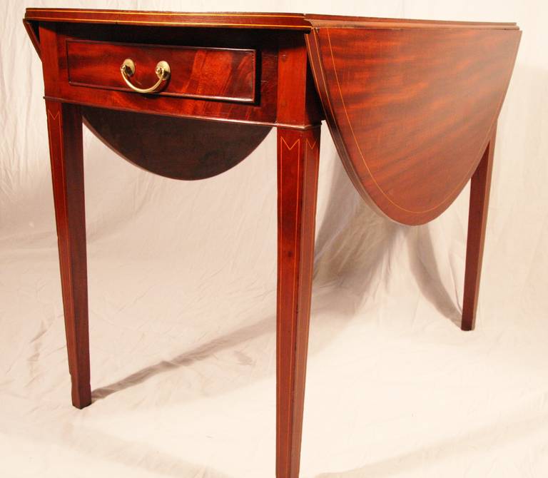 Hepplewhite mahogany Pembroke table.  One board figured mahogany top with hinged 