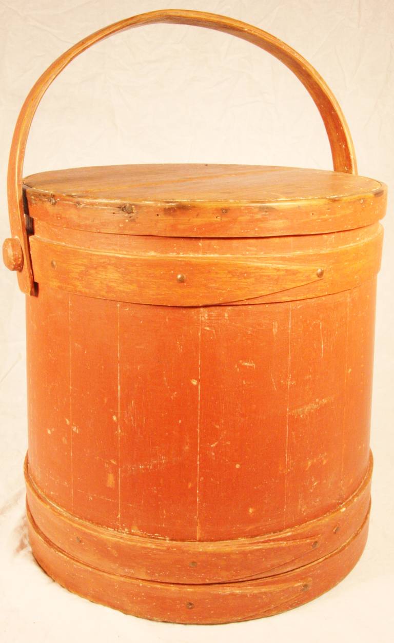 19th century painted softwood covered firkin. Tongue and groove staves, tapered lap joint wood bands, bentwood swing handle with wood peg attachments. Original red paint. Inscribed 