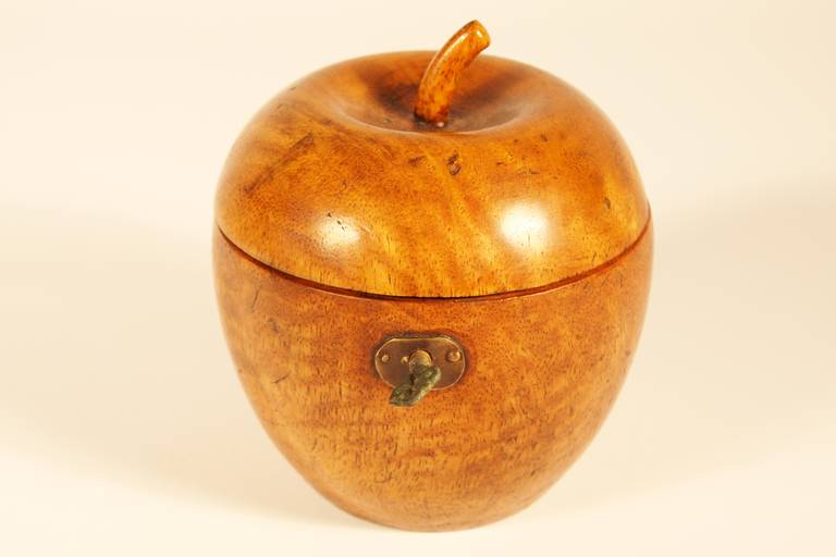 18th century fruitwood carved apple tea caddy with carved stem, original locking mechanism, and key.  Lined with tin paper.  Fine patina.