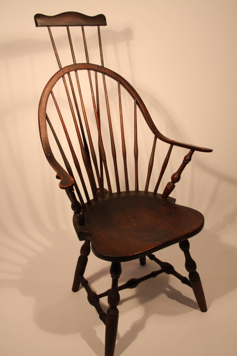 E. B. Tracy Windsor continuous armchair having comb extension back with bold turned arm supports, legs, and stretchers, signed on bottom E. B. Tracy.   Ebenezer Tracy Sr. was considered one of the most preeminent chair makers in CT.

Chairs