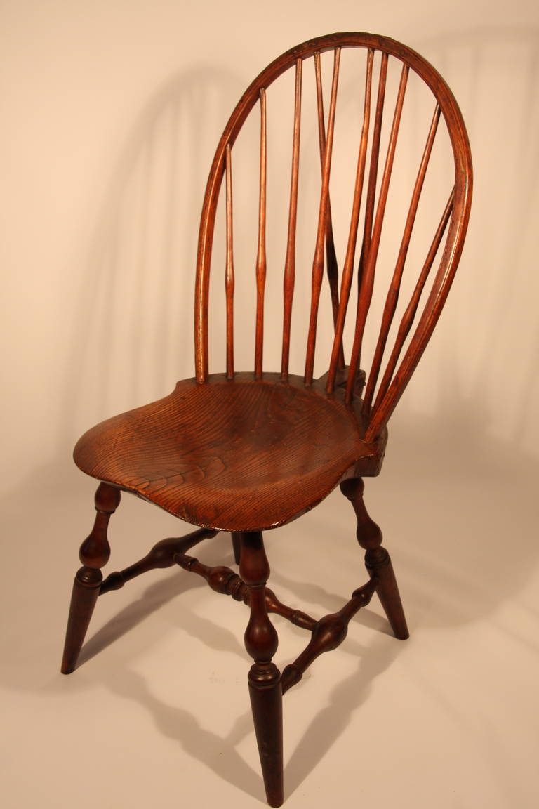 Windsor bowback side chair with bold turned arm supports, legs, and stretchers, signed on bottom E. B. Tracy.   Ebenezer Tracy Sr. was considered one of the most preeminent chair makers in CT.

Chairs produced by him and his son are some of the