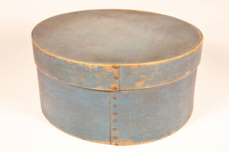Early 19th century, New England round bent wood storage box with square nailed and peg construction.  Good uniform original vibrant dark blue paint.