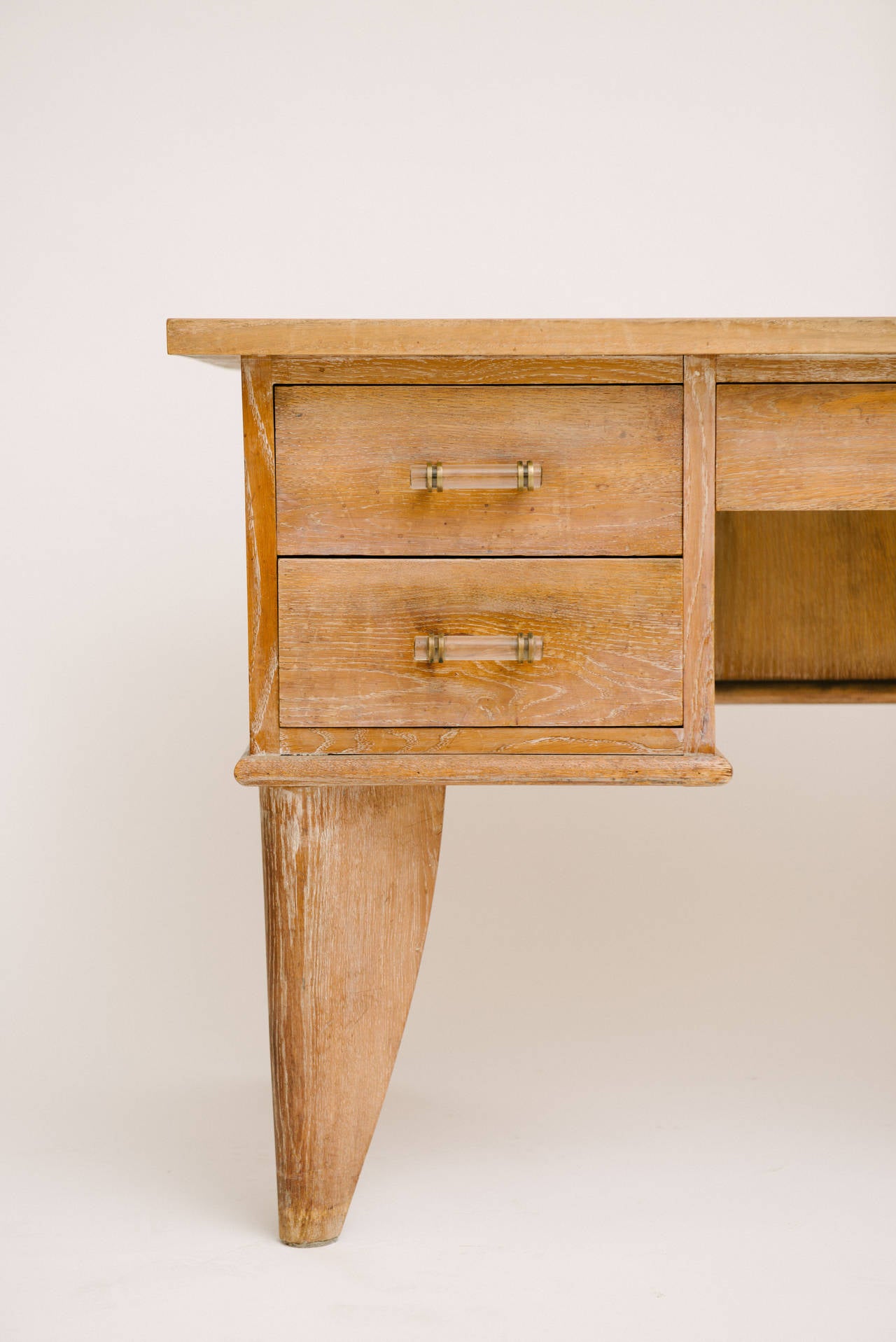 French Art Deco cerused oak desk with glass and bronze handles. Front opening for chair measures 14.5 inches wide.