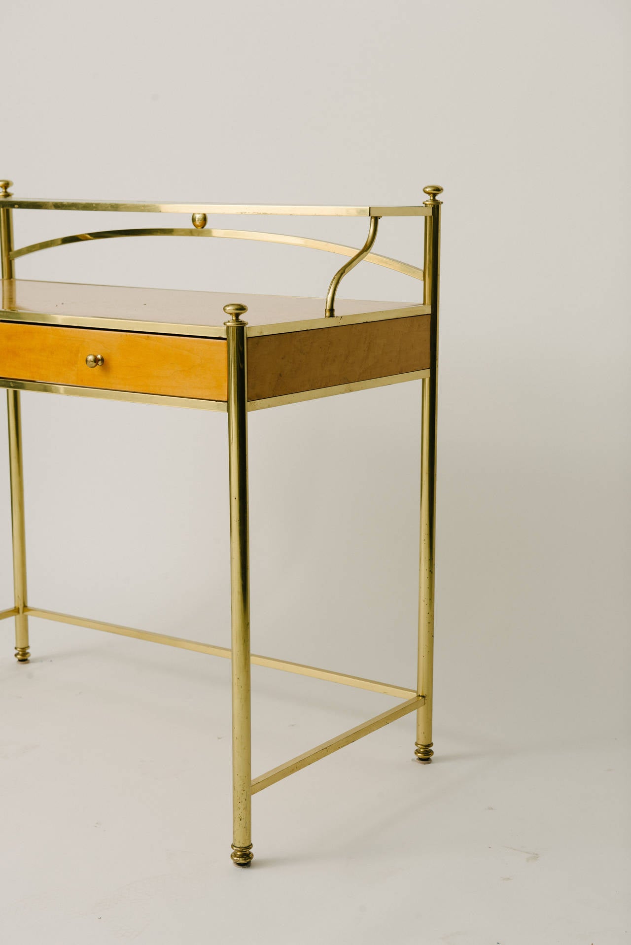 Vintage French vanity with gilt brass frame, glass shelf and two drawers.