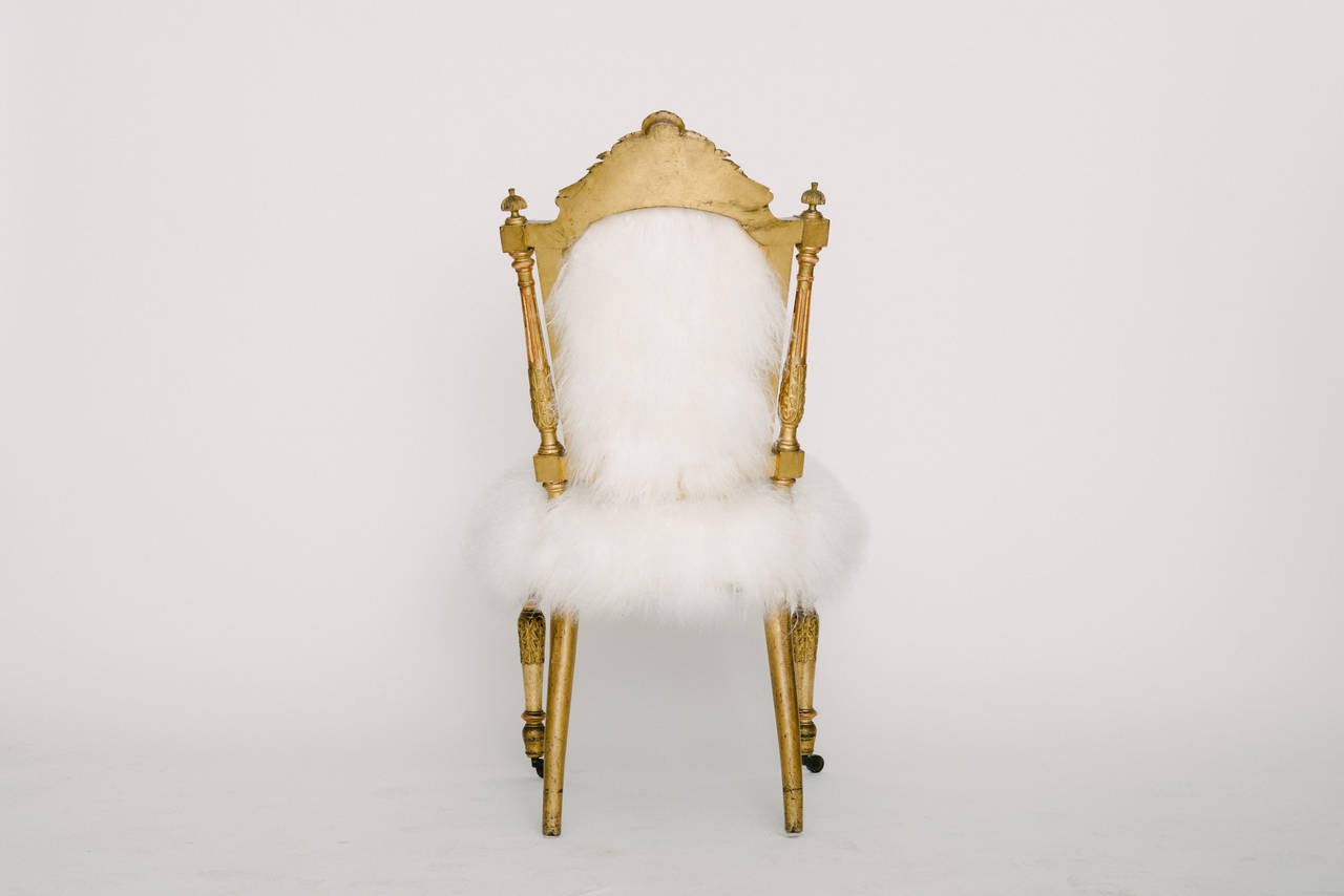 Pair of Louis XVI style giltwood chairs newly upholstered in white Mongolian curly hair.