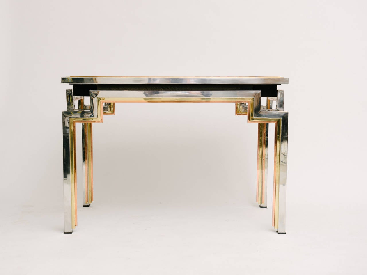 1970s French Backgammon (Tric-Trac) table in copper, brass and chrome. Designed by Alain Delon in 1972 for The Jansen collection. Four removable ashtrays and black suede tabletop lining. Signed by Alain Delon.