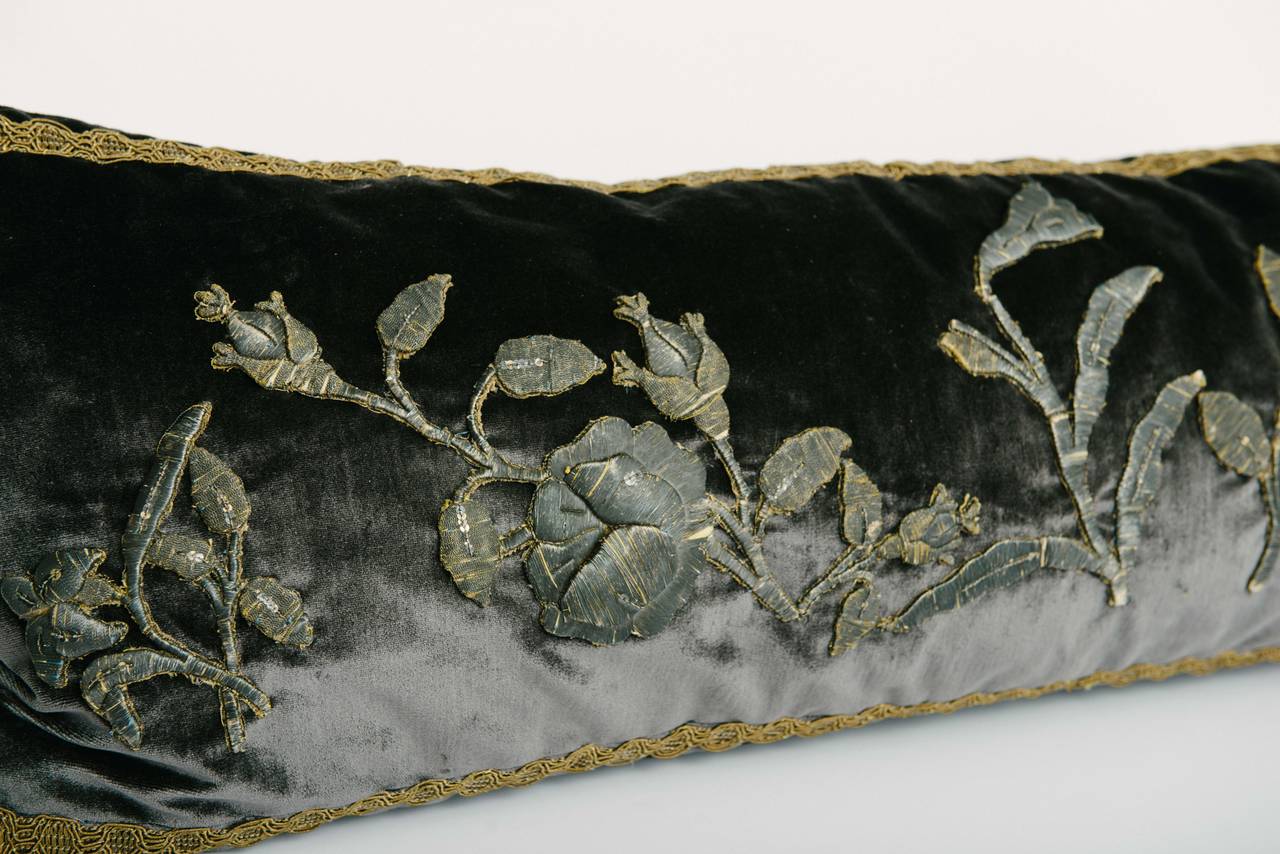 A custom charcoal silk velvet feather down pillow made with 18th-19th century metallic embroidered floral/foliage appliqués and gilded braid trim.