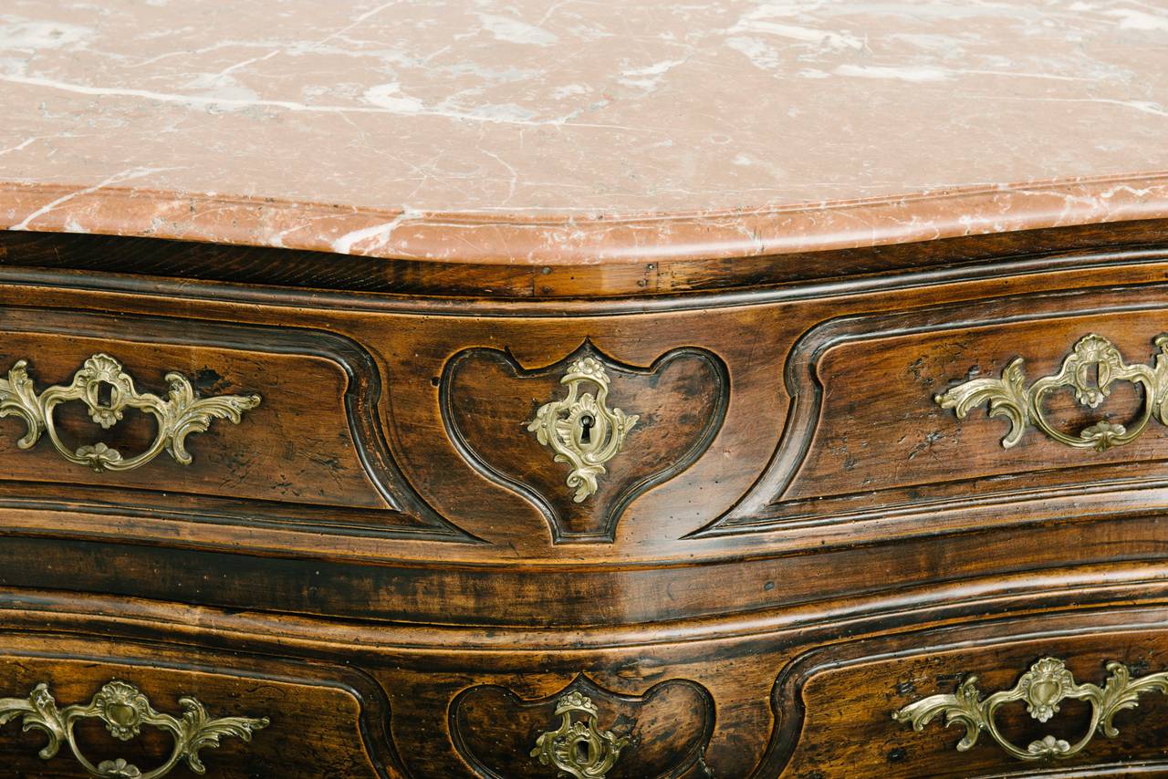 Period French, Louis XV three-drawer walnut commode or chest of drawers with original marble top.