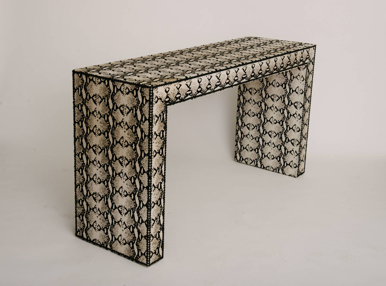 A custom graphic black and white printed snakeskin hair hide Parsons consoles with a matte black nailhead detail. Other custom sizes, material and leathers available.