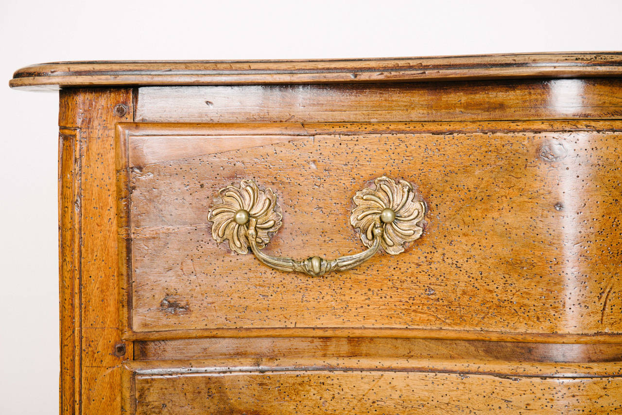 Antique French three-drawer chest of drawers with wave styled front.
