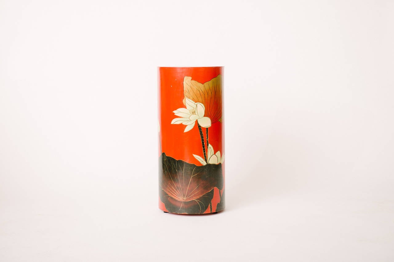 Vintage lacquered red-orange pedestal with graphic painted lotus flowers and leaves.