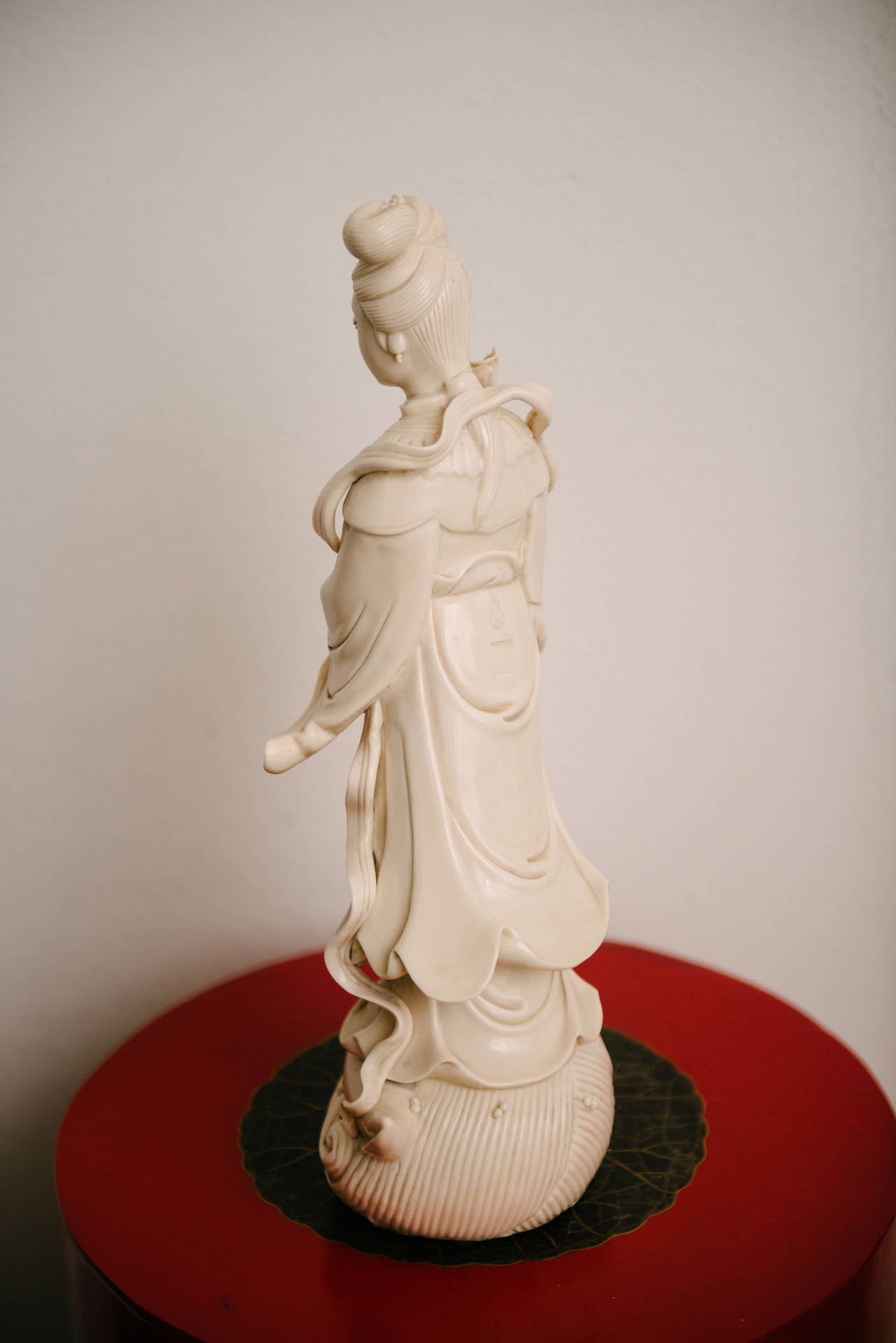 This is a beautiful 19th Century Blanc de Chine Guanyin, Goddess of Mercy, standing on a giant conch shell in ocean waves.