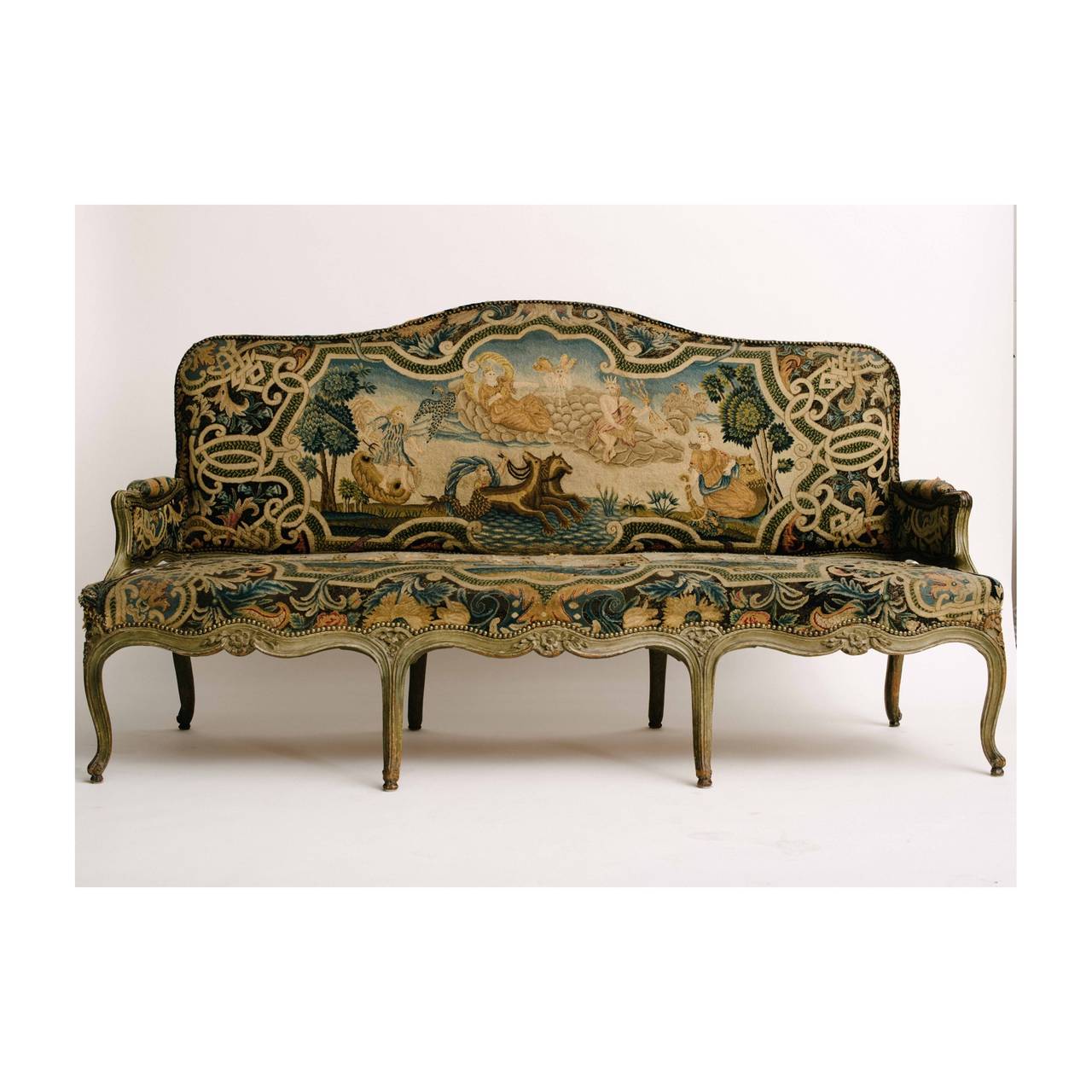 A fabulous carved 18th Century French Louis XV sofa upholstered in an exquisite antique Poseidon and Triton Greek mythology tapestry. Please inquire for pricing.