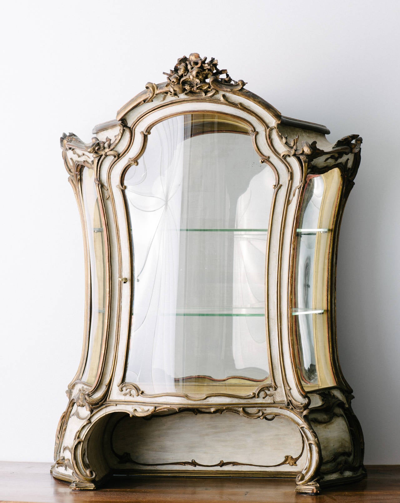 19th century French painted and giltwood vitrine with mirrored back and two glass shelves.