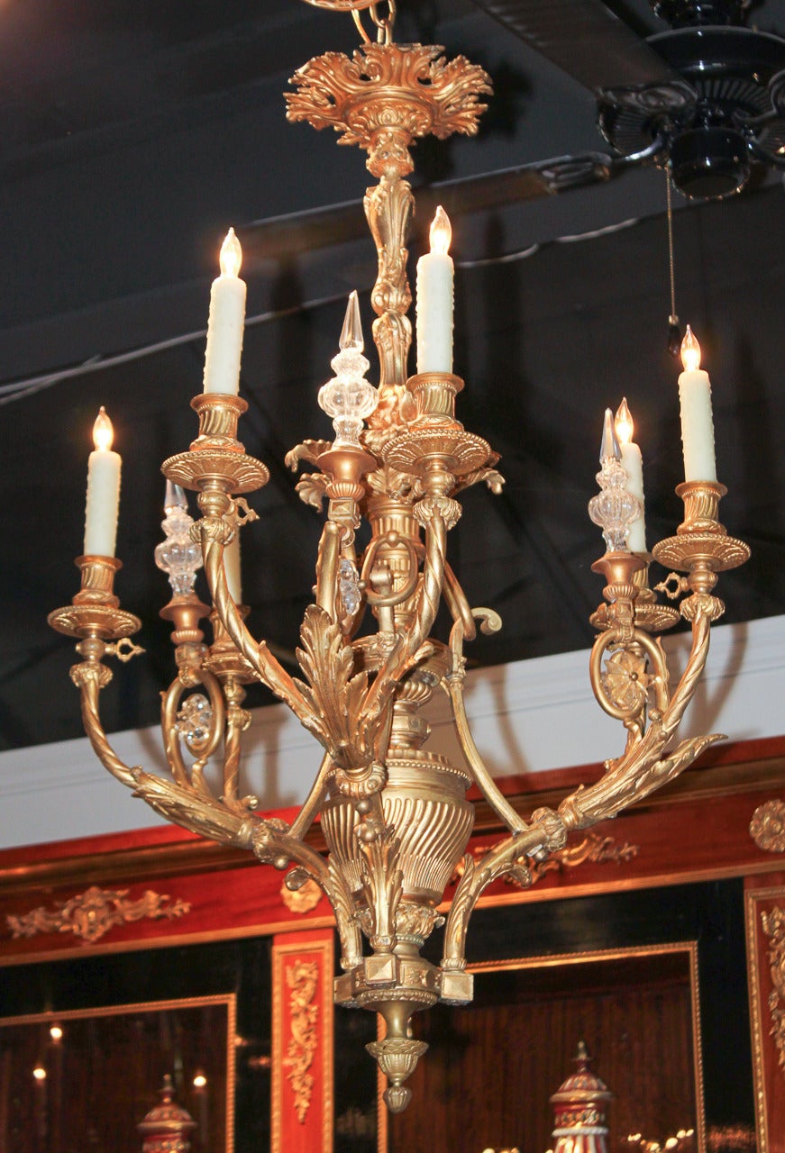 Sensational French gilt bronze 6-light chandelier. Having 3 crystal spires and wonderful scrolling arms in acanthus leaf motif emanating from an impressive central column.