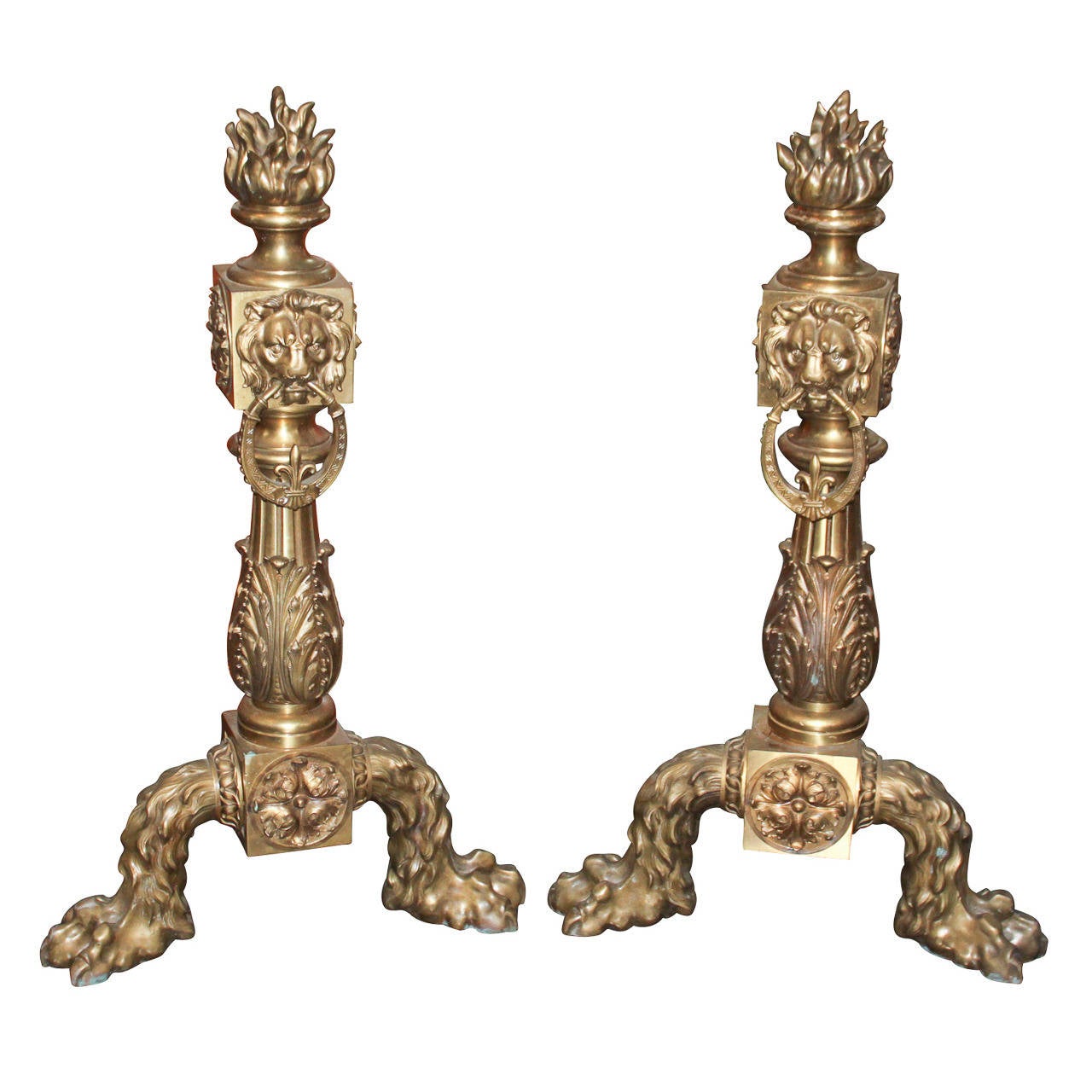 Impressive monumental pair of French heavy gilt bronze andirons. Having wonderful casting, two-legged claw foot base, acanthus leaf and rosette motifs, lion masks and topped with flame finial. A truly sensational pair worthy of many designs!
