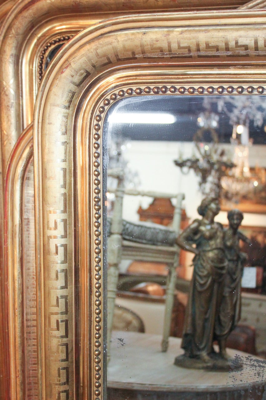 Sensational French Louis Philippe giltwood mirror with greek key motif and beaded frame.  Exhibiting clean lines.