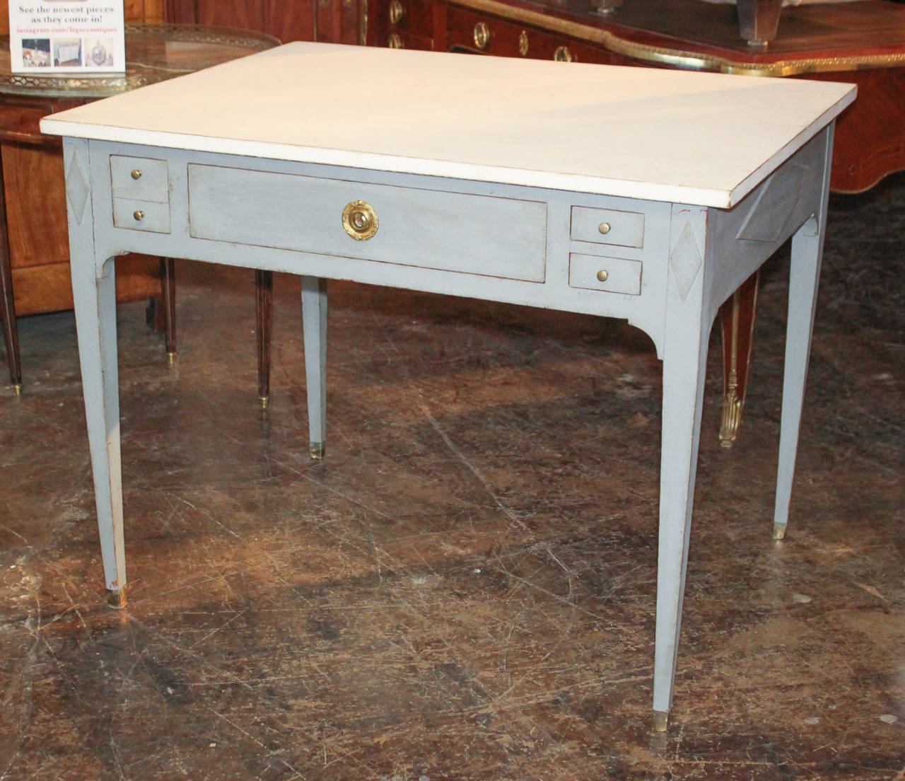 Versatile Swedish Neoclassical 4-drawer painted occasional table.  Having stylish painted finish, bronze hardware, and resting on tapered legs.  Exhibiting clean lines that work in countless styles of decor!