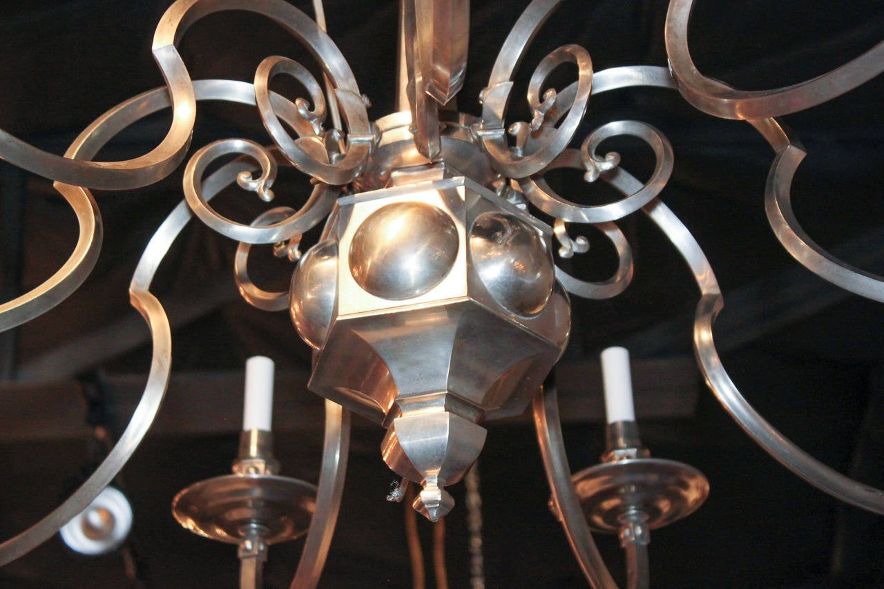 Fabulous English 8-light chandelier with pewter finish.  Having outswept angled arms terminating in large bobeche, and with attractive hexagonal central column.  Exhibiting a beautiful finish and clean lines that work in countless styles of decor!