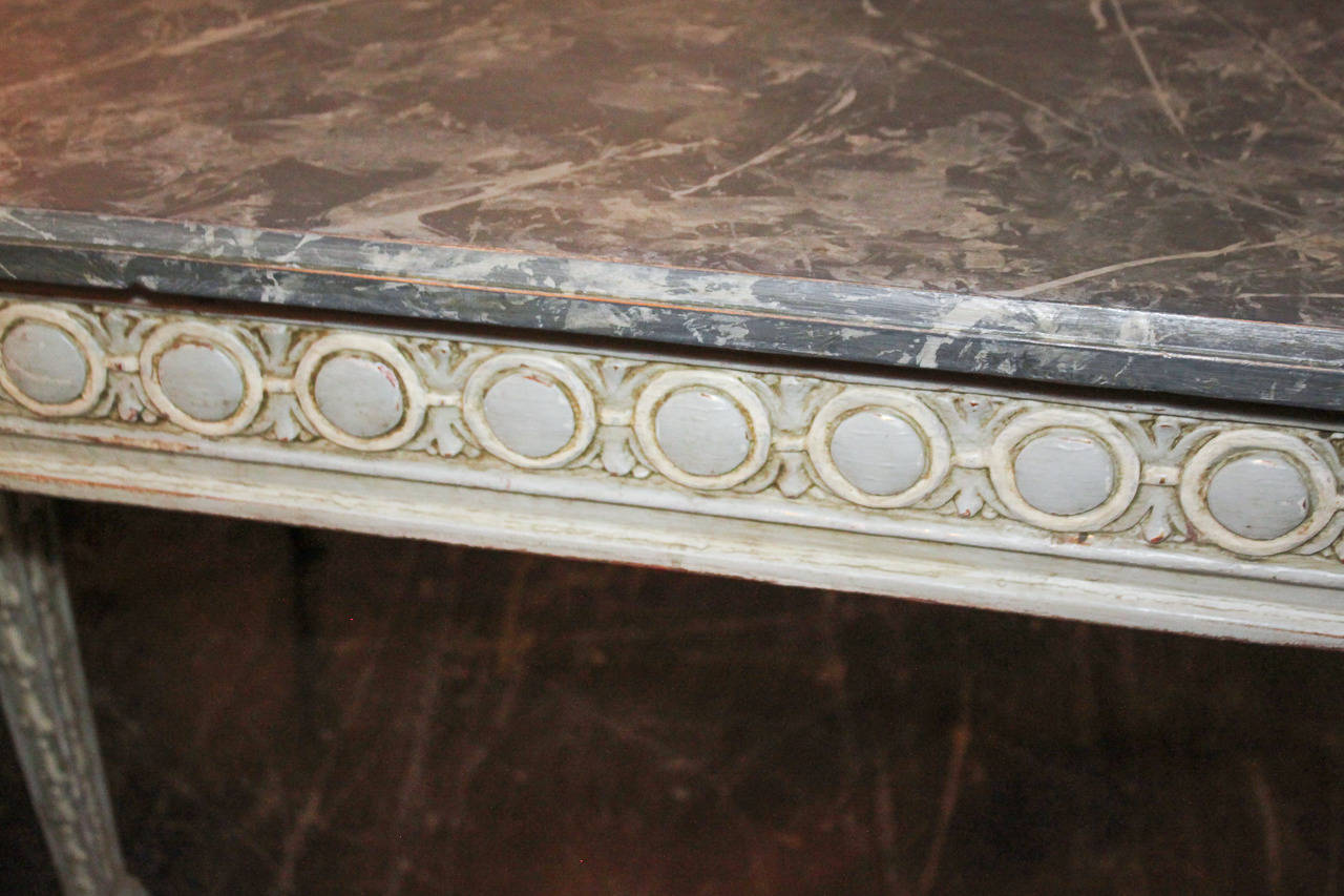 Wonderful French Louis XV hand-carved and lacquered console with faux marble top.  Having beautiful aged lacquered finish, versatile circular motif along frieze, resting on carved tapered legs, and clean lines.