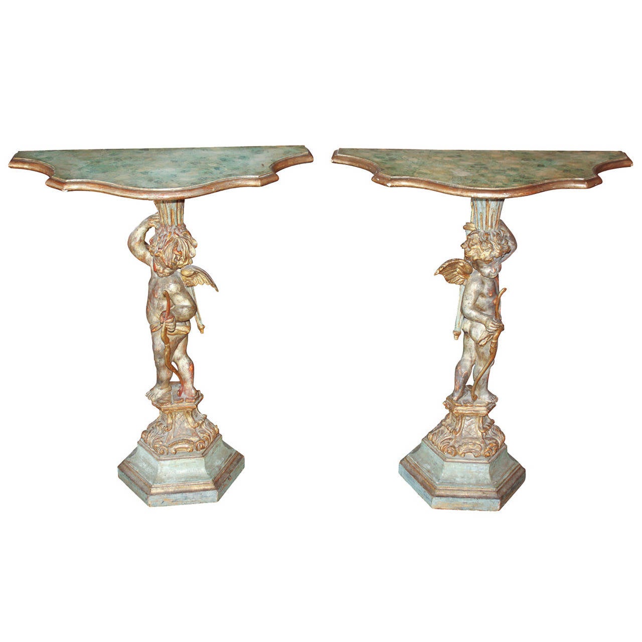 Sensational pair of Italian polychrome cherub-form side tables. Each having a hand carved cherub holding a bow and resting on hexagonal base with acanthus leaf motif. Exhibiting excellent aged polychrome finish.