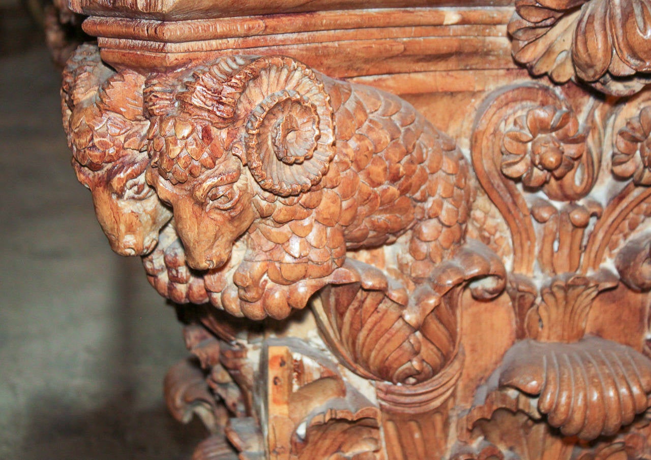 Impressively hand-carved Italian Neoclassical pine console with slate top.  Having exceptionally detailed carvings of ram heads, floral, and acanthus leaf motifs. 