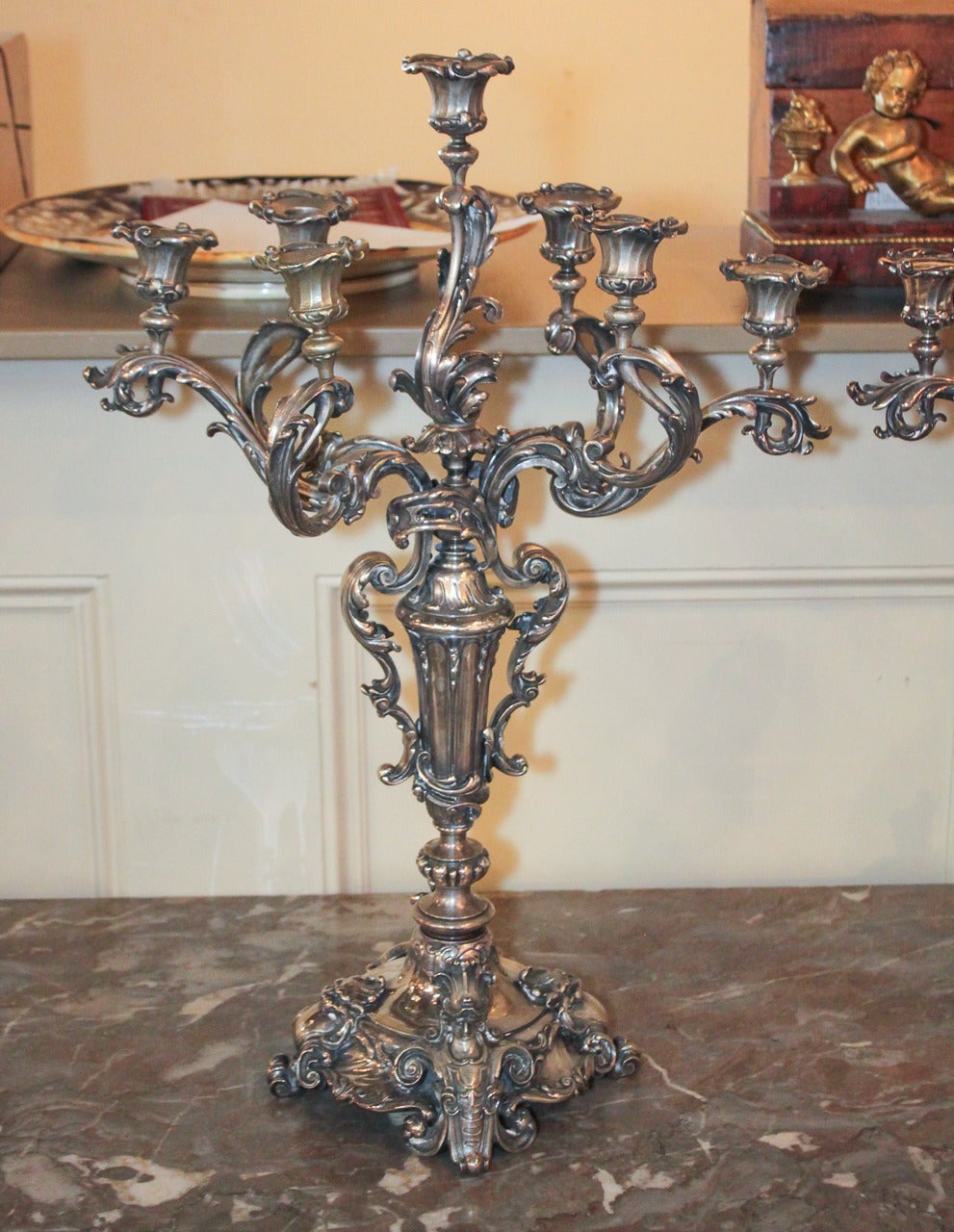 Sensational pair of Continental silvered bronze 7-candle candelabra.  Having ornate acanthus leaf motif arms and detailing, figural and lions head motifs on bases, and an elegant finish. 
