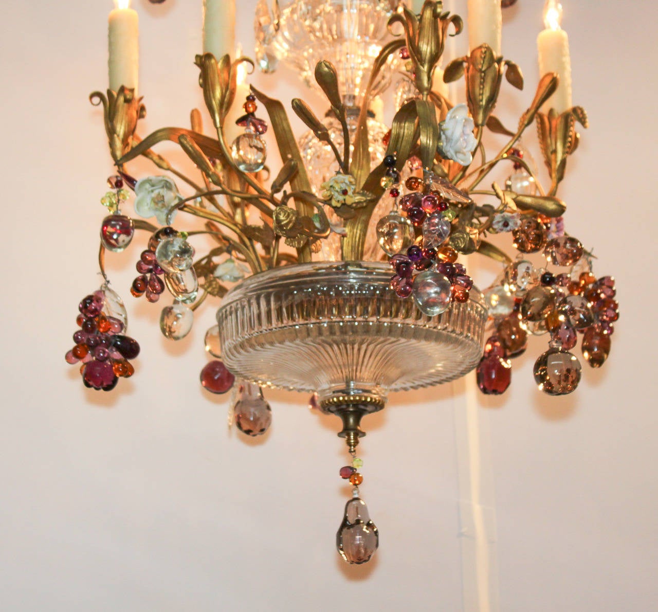 Exceptional French bronze doré bronze, crystal, and amethyst eight-light chandelier. Having three tiers of floral motif adornments, arms and candle-cups in floral design, amethyst and crystal grape clusters, and impressive central column. A