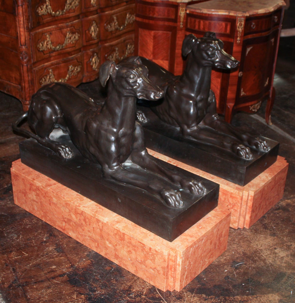 Stately pair of French style cast bronze whippets resting on sienna marble platform bases. Having lovely size and proportions.