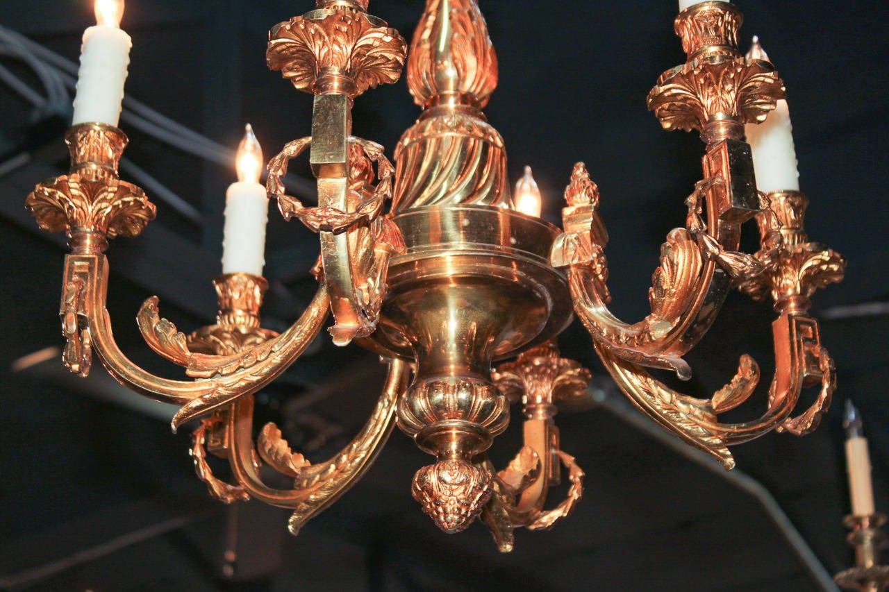 Lovely French heavy-cast gilt bronze 6-light chandelier with acanthus leaf motif.  Motif flows along arms and is continued on bobeches and candle cups.  Having wonderful proportions and is beyond chic for numerous designs!