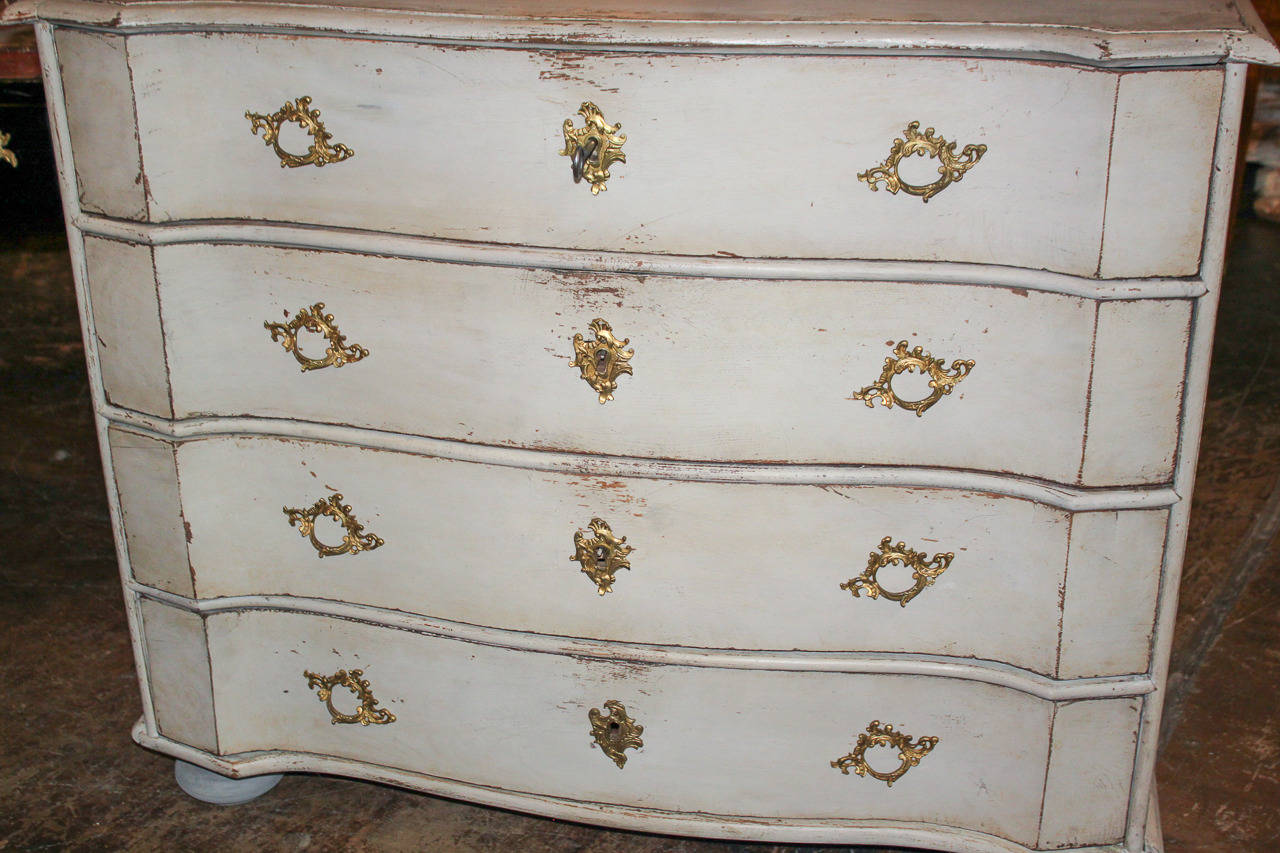 Handsome Swedish 4-drawer painted commode with shaped front. Having wonderful aged, painted finish and accented with bronze hardware. Perfect for today's stylish decors!