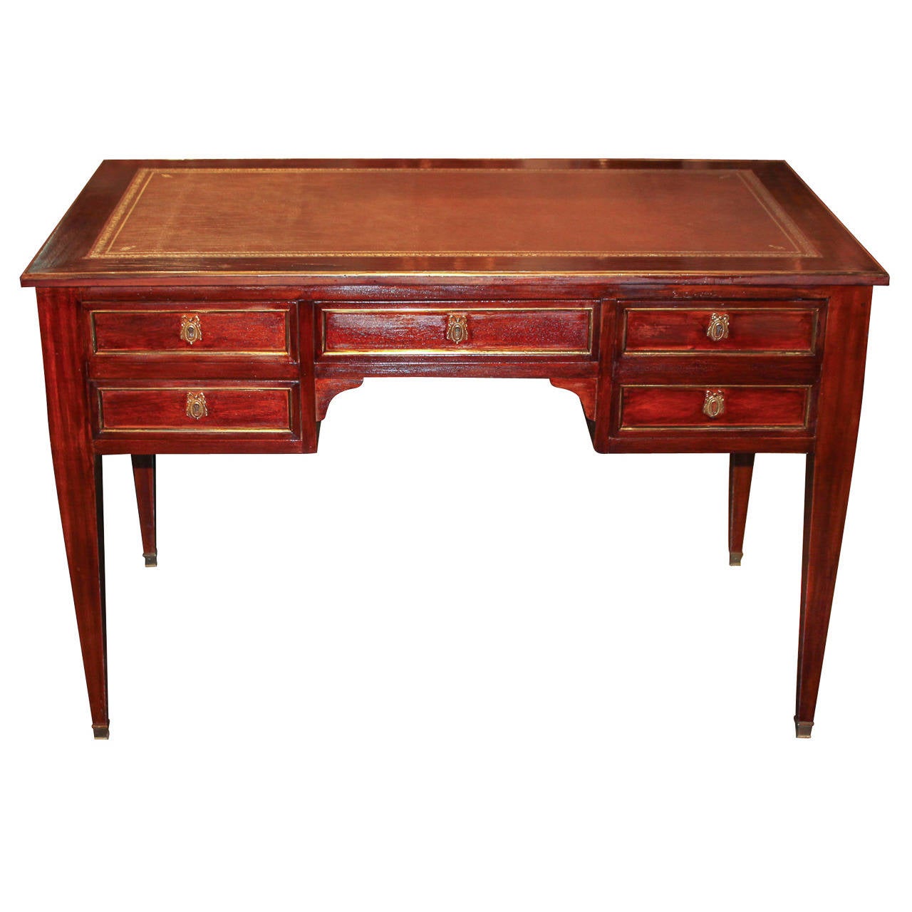 Attractive French Directoire mahogany writing desk with leather top and brass trim.  Having 5 drawers, each with brass trim and bronze mounts, and resting on tapered legs.  